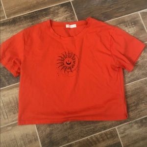 Orange crop top with a sun and moon detail from ROMWE
